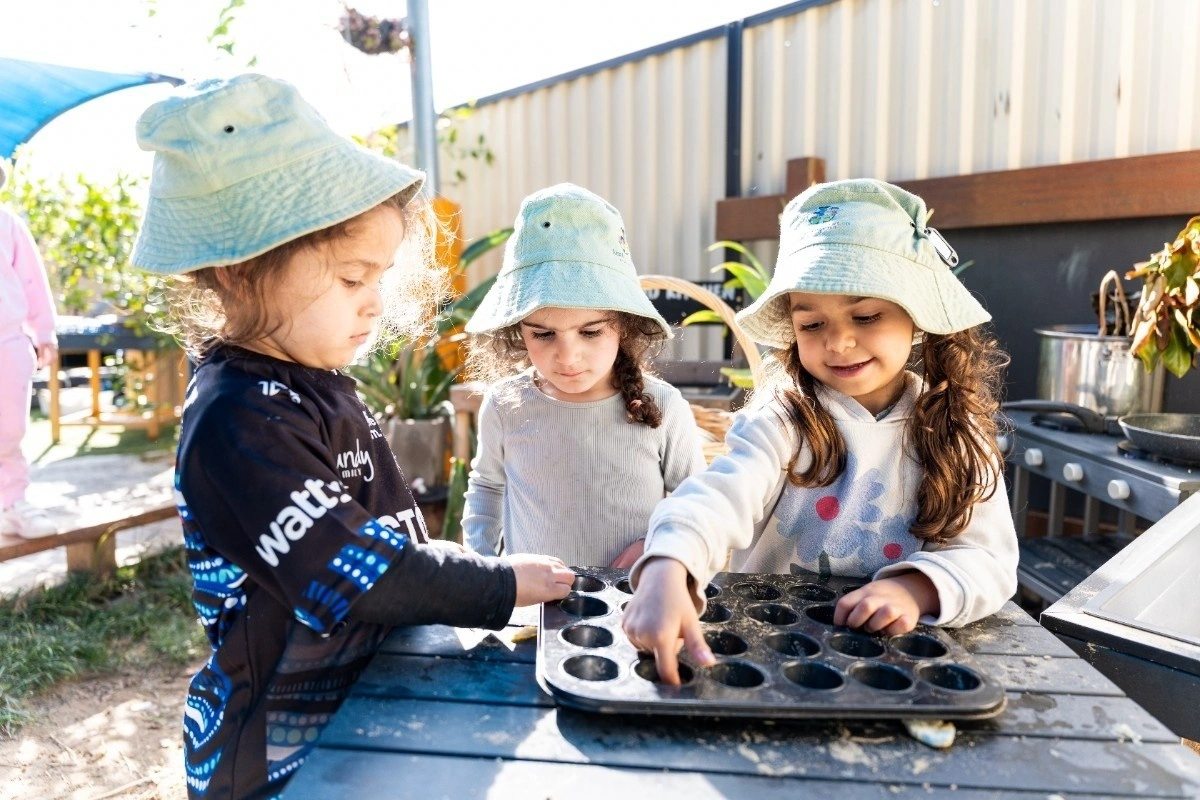 Preschool children doing outdoor learning activities together