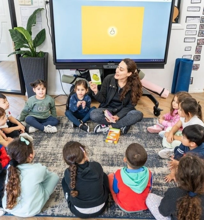 Teacher with children during a classroom learning activity.